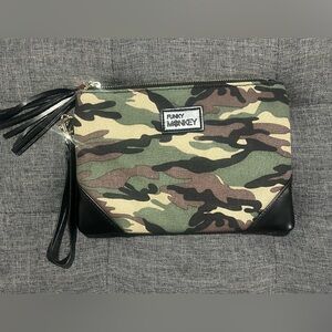 Camouflage clutch with gold hardware and black faux leather, red lining.